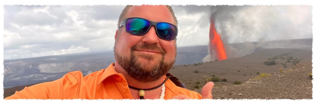 Scott Bier, private Big Island volcano tour guide, standing near an active lava eruption at Hawaiʻi Volcanoes National Park