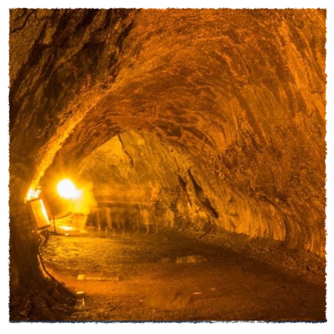 Interior of Nāhuku Lava Tube in Hawai‘i Volcanoes National Park, showing a glowing lava-carved tunnel lit from within.