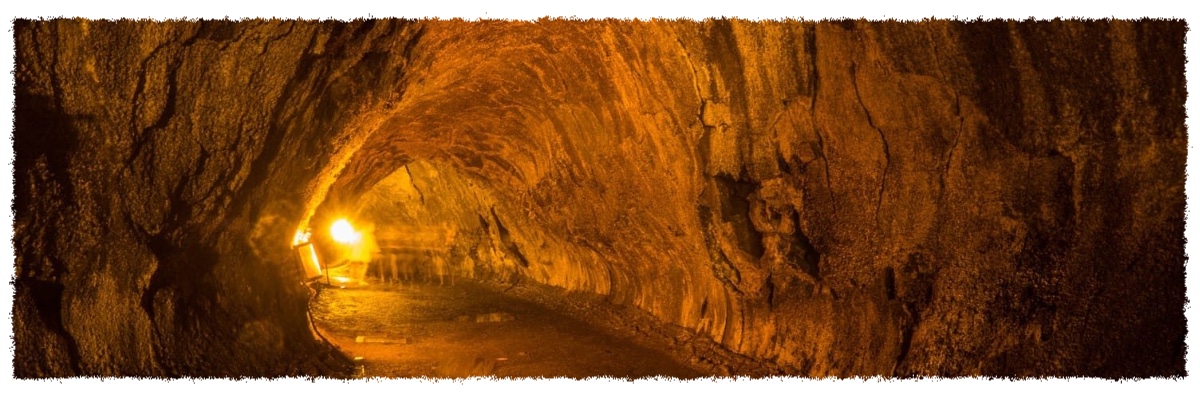 Interior of Nāhuku Lava Tube in Hawai‘i Volcanoes National Park, showing a glowing lava-carved tunnel lit from within.