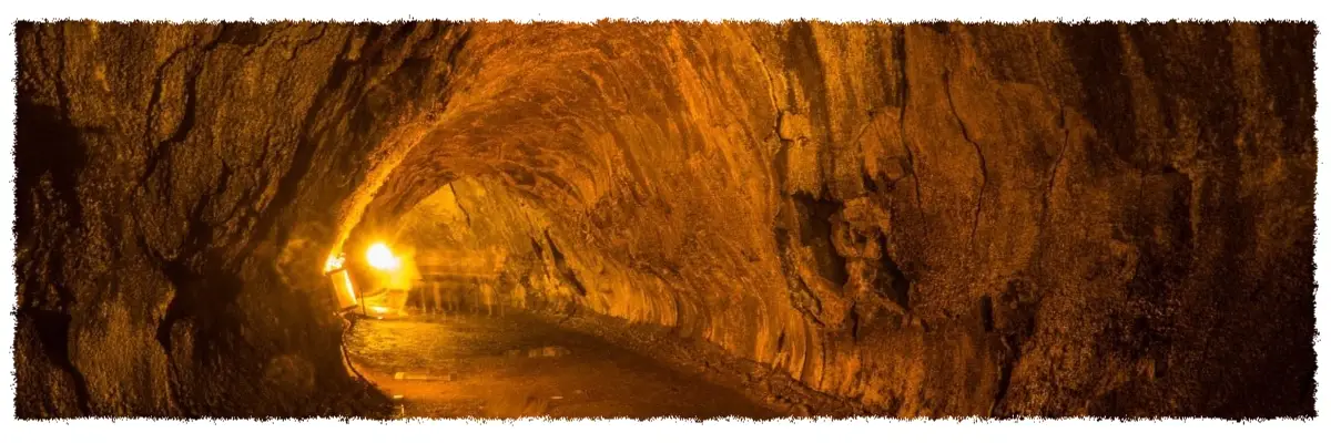 Interior of Nāhuku Lava Tube in Hawai‘i Volcanoes National Park, showing a glowing lava-carved tunnel lit from within.