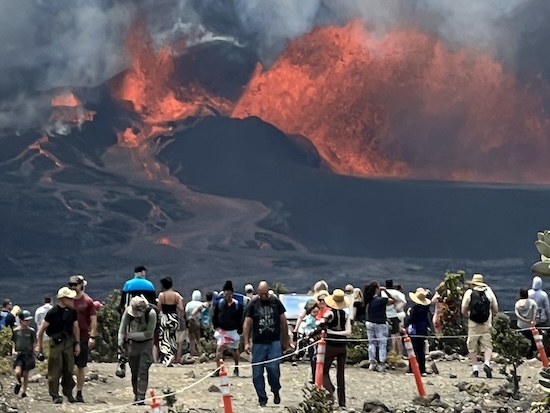 Spectators watch an eruption at Kilauea.