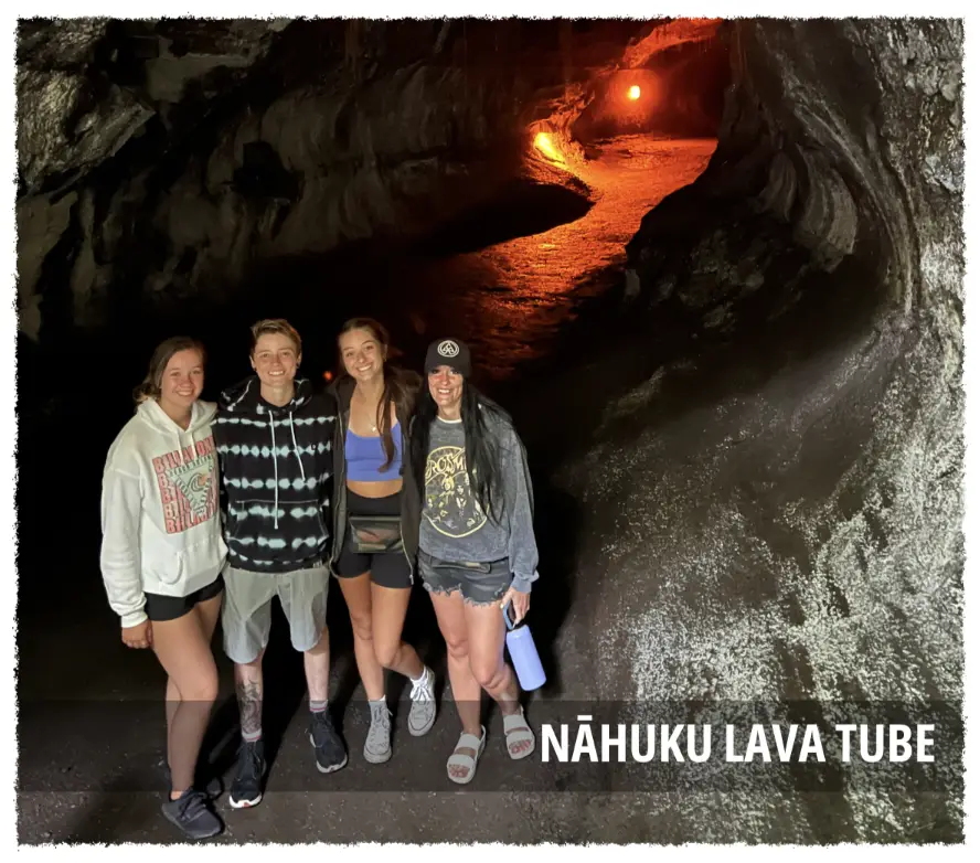 Guests exploring Nāhuku (Thurston) Lava Tube in Hawaiʻi Volcanoes National Park, standing inside a naturally formed lava tunnel lit by warm volcanic light.